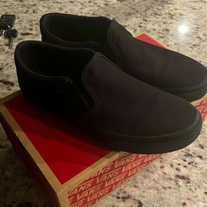 All black Vans slip ons